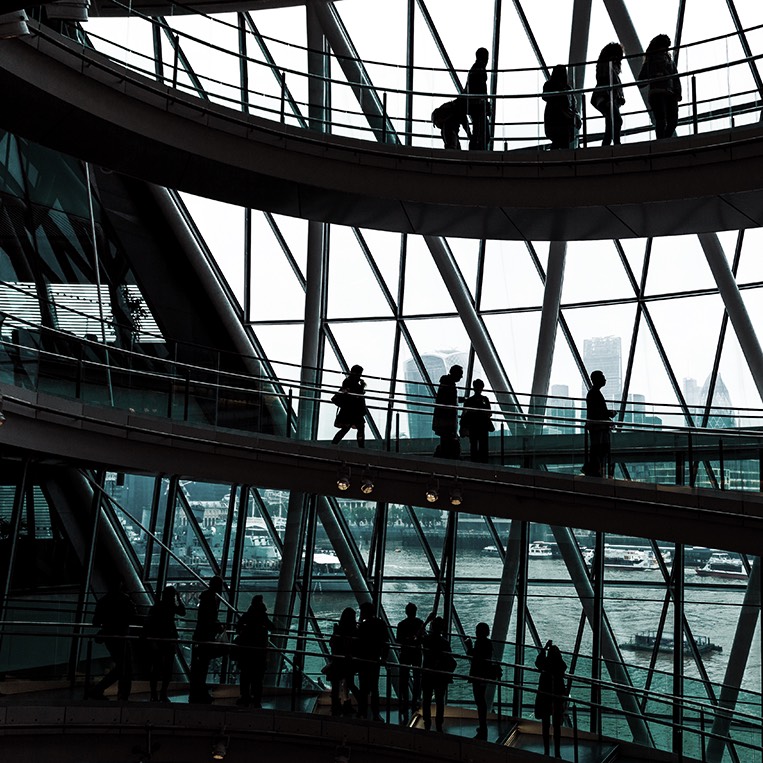 People in front of windows in a building